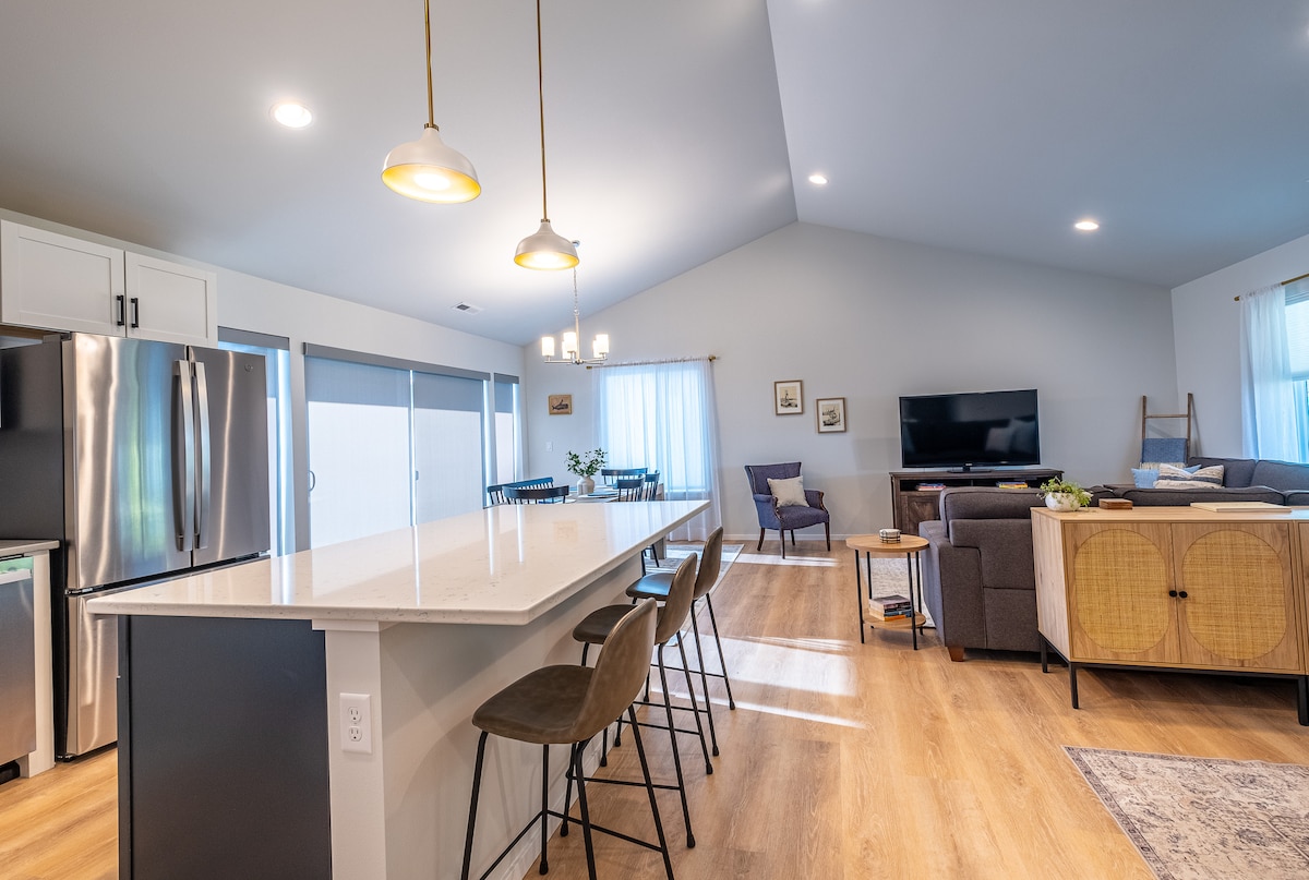 Open kitchen with island, dining area and living room