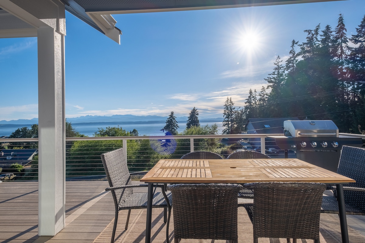 Deck dining set and propane grill overlooking the water
